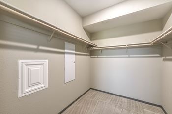 Walk-in closet with hanging rods and shelving